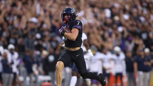 TCU Horned Frogs wide receiver JP Richardson (7) runs for a touchdown after catching a pass against West Virginia Mountaineers safety Anthony Wilson (12) in the first quarter at Amon G. Carter Stadium.